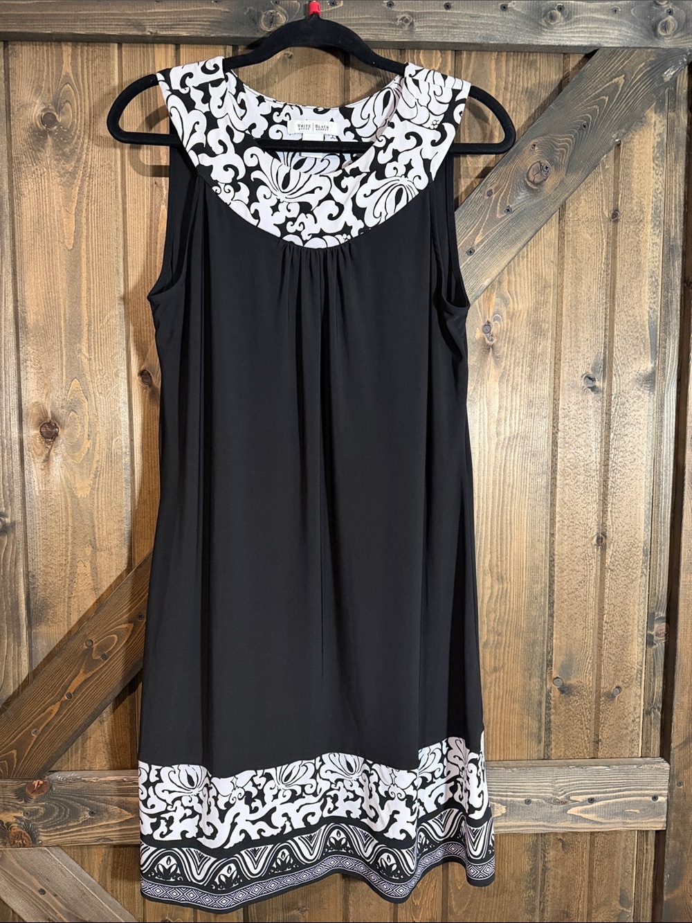 Sleeveless Black Dress with White Scroll Trim